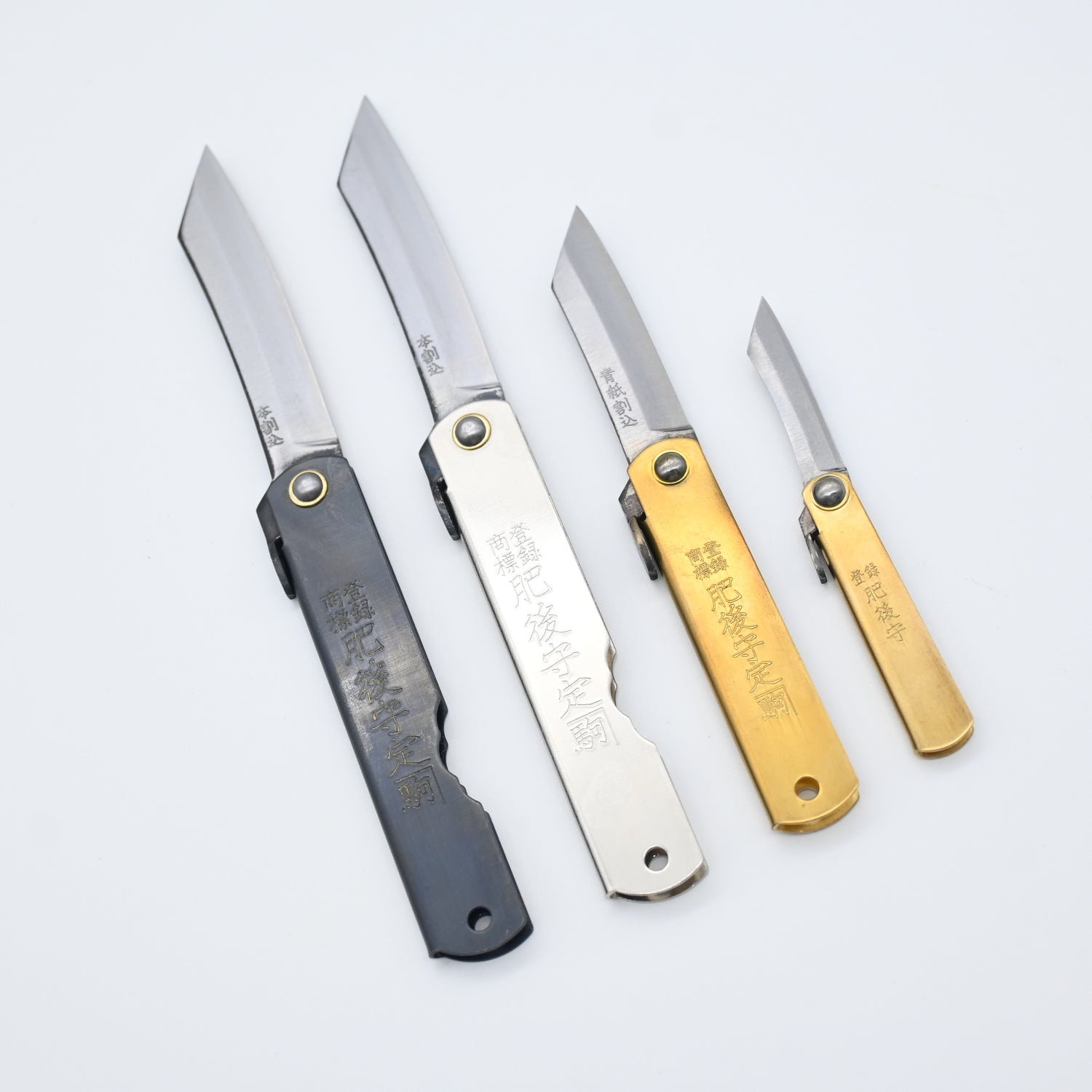 Four folding knives in different colors on a white background